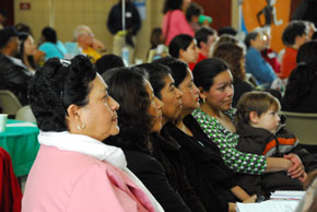 Hispanic Women Seated at Conference 