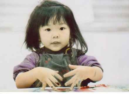 Photo of a Little Girl Finger Painting