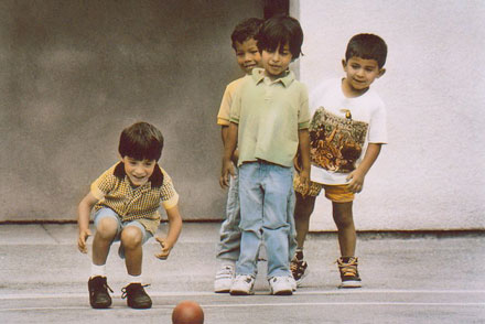 Photo of Four Little Boys Playing Kick Ball